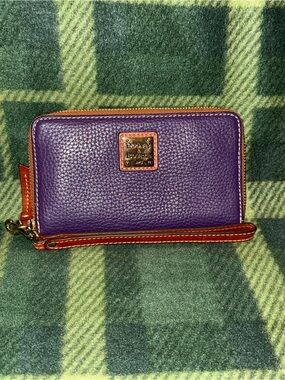 Dooney and Bourke zip around wallet in plum